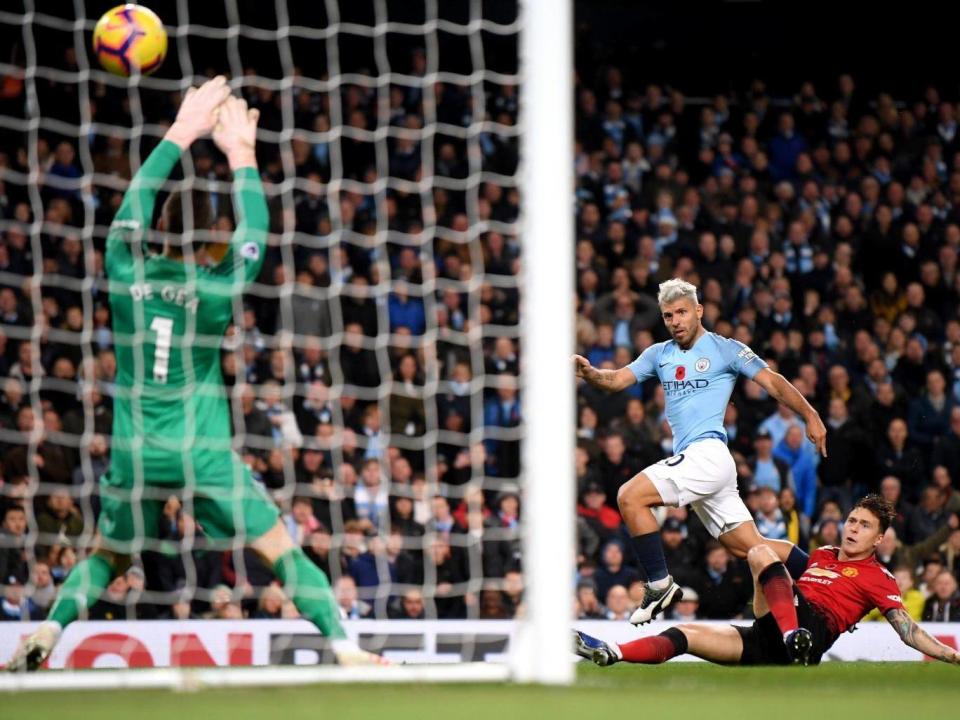 Aguero fires the ball above David De Gea for City's second goal (Getty)