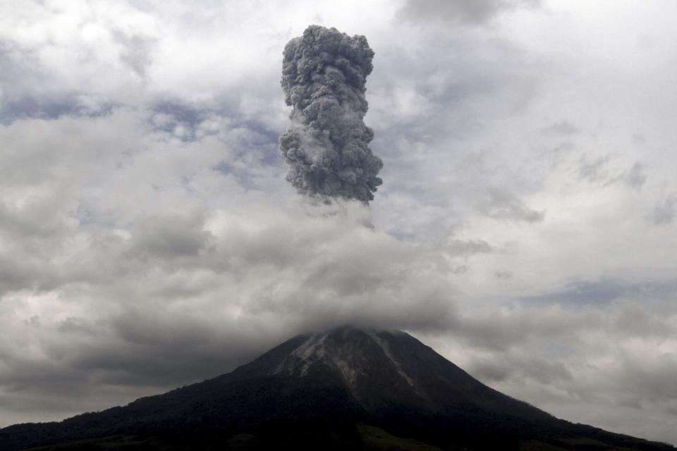 Mount Sinabung spews ash as it is pictured from Simpang Empat village in Karo district