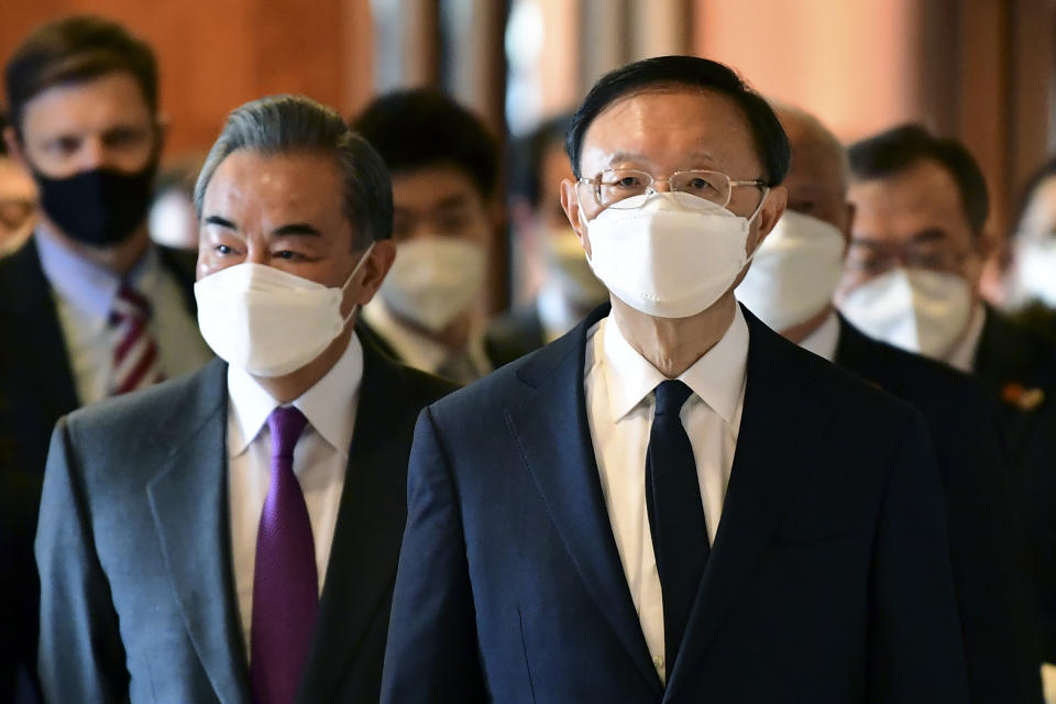 Chinese Communist Party foreign affairs chief Yang Jiechi, right, and China's State Councilor Wang Yi, left, arrive for the opening session of US-China talks at the Captain Cook Hotel in Anchorage, Alaska, Thursday, March 18, 2021. (Frederic J. Brown/Pool via AP)