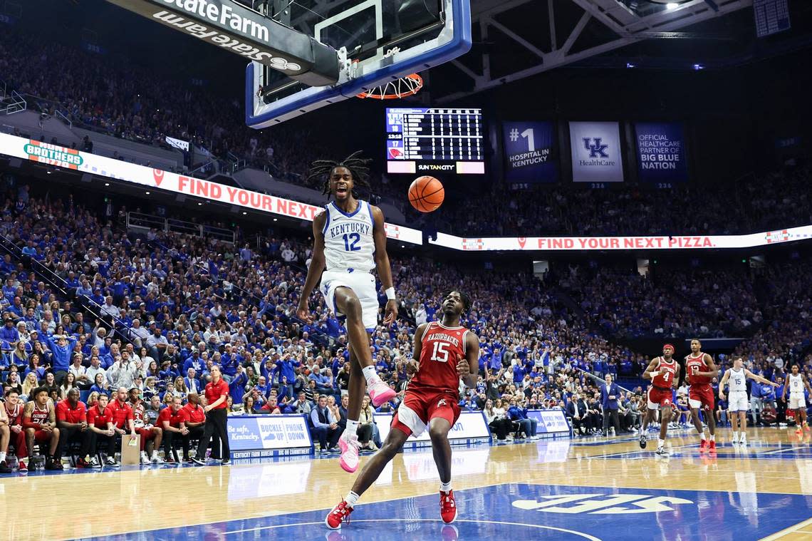 Kentucky guard Antonio Reeves (12) dunks against Arkansas forward Makhi Mitchell (15) on a breakaway play during Saturday’s game at Rupp Arena. Reeves has now scored at least 20 points in five straight games for the Wildcats.