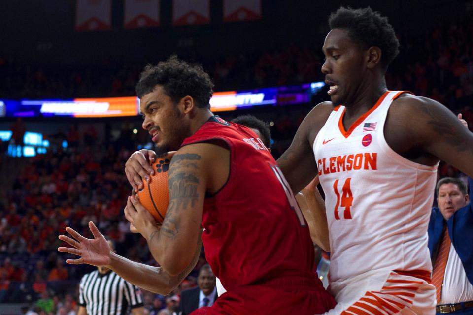 Louisville Cardinals guard Quentin Snider (4) protects the ball while being defended by Clemson Tigers forward Elijah Thomas (14) during the first half at Littlejohn Coliseum in Clemson, South Carolina, on Saturday, Jan. 6, 2018.