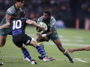 Australia's Marika Koroibete, right, charges toward Argentina's Nicolas Sánchez during their Tri-Nations rugby union match in Sydney, Australia, Saturday, Dec. 5, 2020. (AP Photo/Rick Rycroft)