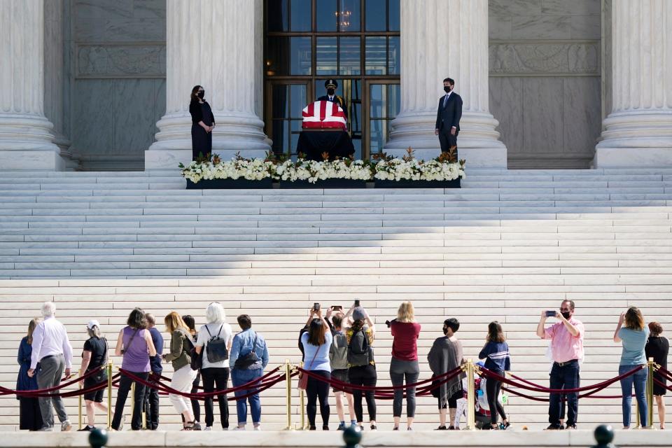 People pay respects as Justice Ruth Bader Ginsburg lies in repose under the portico at the top of the front steps of the U.S. Supreme Court Sept. 23, 2020.