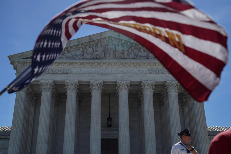 <p>A man holds a flag outside the U.S. Supreme Court, as the Trump v. Hawaii case regarding travel restrictions in the U.S. remains pending, in Washington, June 25, 2018. (Photo: Toya Sarno Jordan/Reuters) </p>