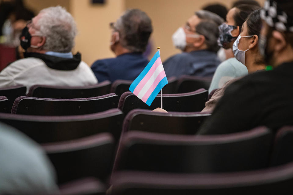 A transgender flag is held at a Las Cruces Public Schools school board meeting at the LCPS administration building in Las Cruces on Tuesday, Dec. 14, 2021.