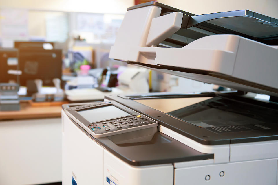 Close-up photocopier or printer is office worker tool equipment for scanning and copy paper.