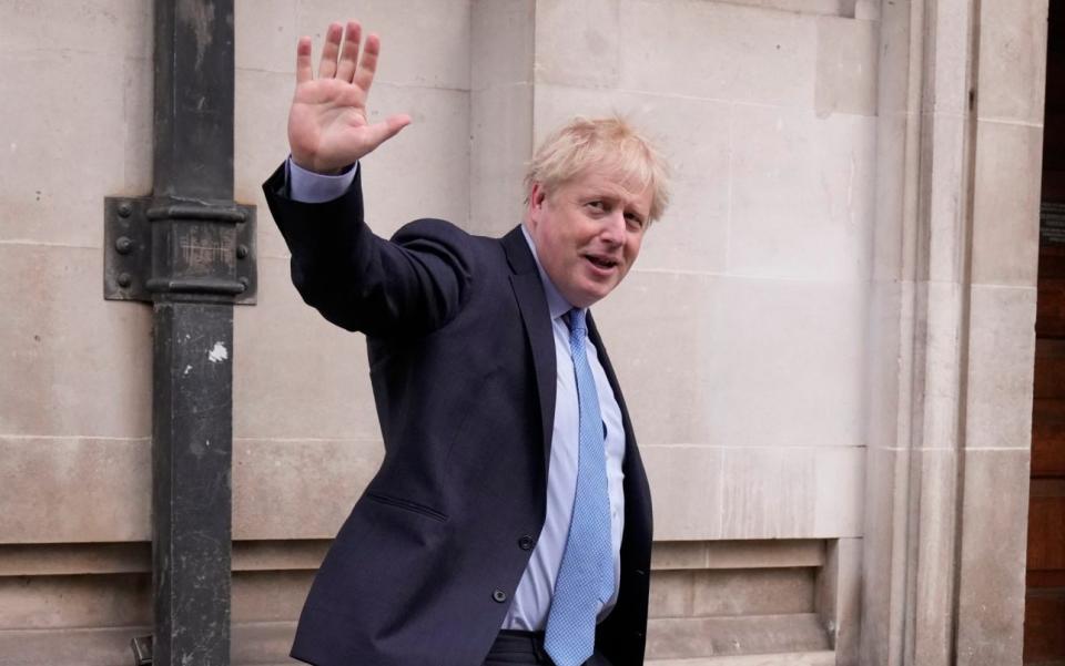 Mr Johnson leaves a polling station on Thursday - Matt Dunham /AP