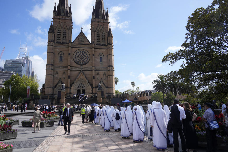 Clergy members and mourners line up to enter St. Mary's Cathedral before the funeral and interment of polarizing Cardinal George Pell in Sydney, Thursday, Feb. 2, 2023. Pell, who died last month at age 81, spent more than a year in prison before his sex abuse convictions were overturned in 2020. (AP Photo/Rick Rycroft)