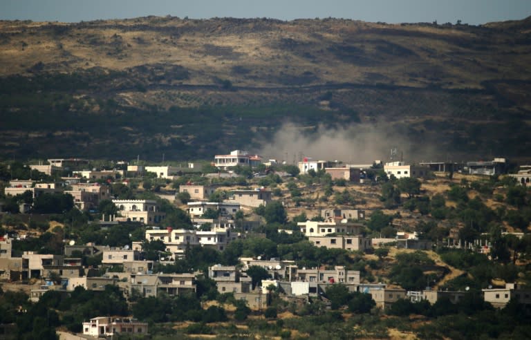 A picture taken from Golan Heights shows smoke rising in the Syrian Druze village of Hadar on June 20, 2015, following Syrian army airstrikes against opposition rebel fighters