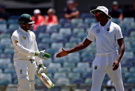 Cricket - Australia v South Africa - First Test cricket match - WACA Ground, Perth, Australia - 7/11/16. South Africa's Kagiso Rabada (R) shakes hands with Australia's Usman Khawaja after he was dismissed LBW at the WACA Ground in Perth. REUTERS/David Gray