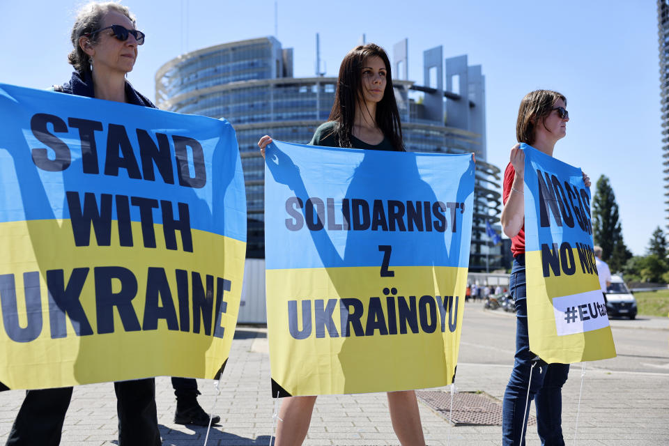 Climate activists claiming the war in Ukraine exposes the EU's dependence on Russian fossil gas, demonstrate outside the European Parliament , Tuesday, July 5, 2022 in Strasbourg, eastern France. (AP Photo/Jean-Francois Badias)