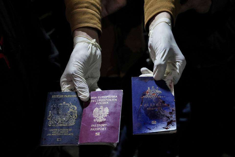 A man displays blood-stained British, Polish, and Australian passports after an Israeli airstrike, in Deir al-Balah, Gaza Strip, Monday, April 1, 2024. Gaza medical officials say an apparent Israeli airstrike killed four international aid workers with the World Central Kitchen charity and their Palestinian driver after they helped deliver food and other supplies to northern Gaza that had arrived hours earlier by ship. (AP Photo/Abdel Kareem Hana)