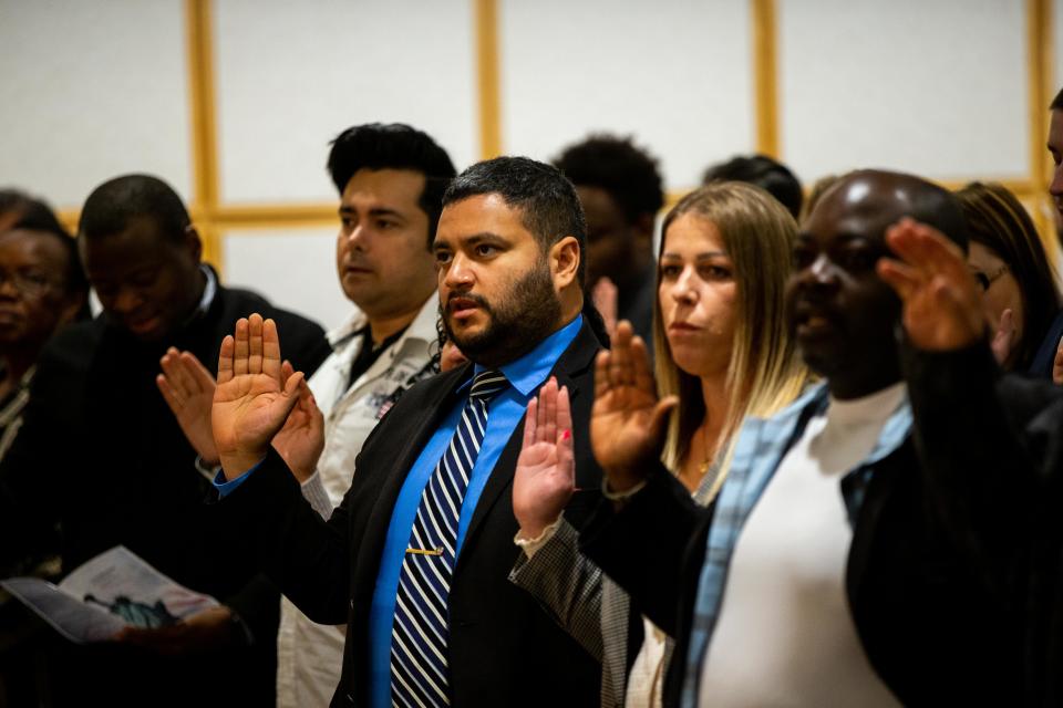 Dozens of people from across the globe were granted U.S. citizenship during a naturalization ceremony Thursday, Oct. 20, 2022, at Herrick District Library in Holland.