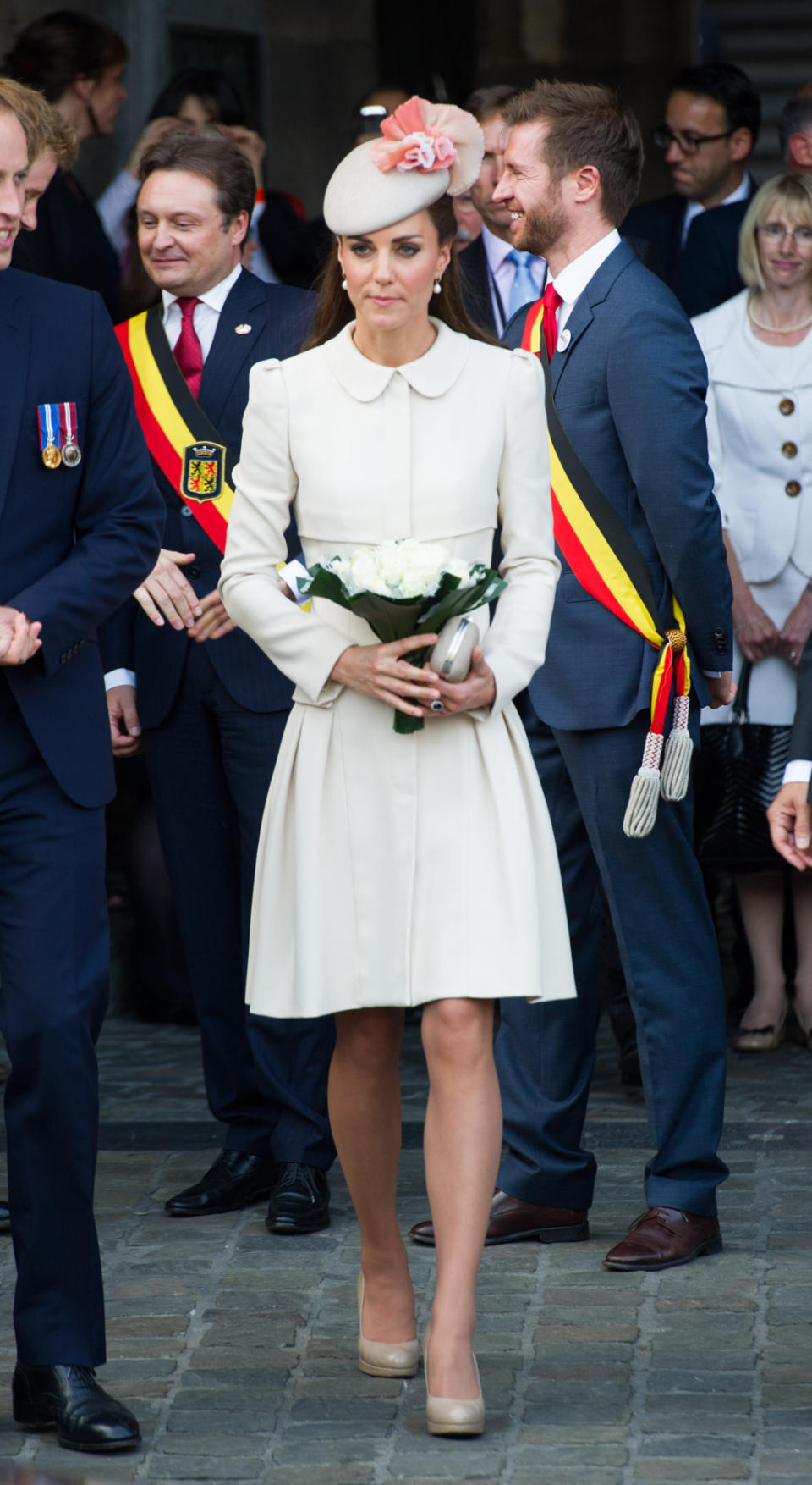 Middleton wore an Alexander McQueen cream coat dress and clutch, LK Bennett shoes, and a Jane Taylor hat to commemorate the 100th anniversary of the start of WWI in Belgium.