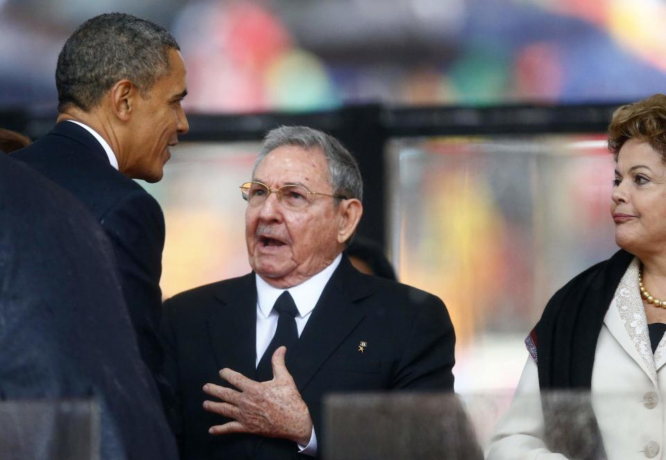 File photo of U.S. President Obama greeting Cuban President Castro at the memorial service for Mandela in Johannesburg