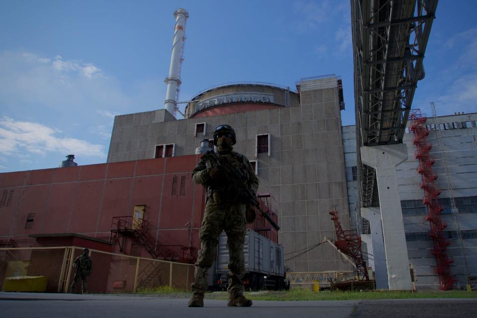 A Russian serviceman stands guard outside the second reactor of the Zaporizhzhia Nuclear Power Station in Energodar, Ukraine, in a May 1, 2022 file photo. / Credit: ANDREY BORODULIN/AFP/Getty
