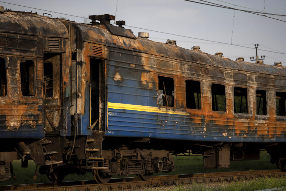 A heavily damaged train is seen at a train station after a Russian attack Wednesday during Ukraine's Independence Day in the village Chaplyne, Ukraine, Thursday, Aug. 25, 2022. (AP Photo/Leo Correa)