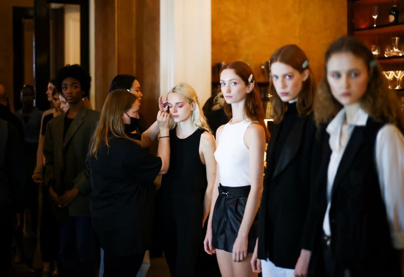 Models prepare backstage for the Bora Aksu Spring/Summer 2022 catwalk show at London Fashion Week in London