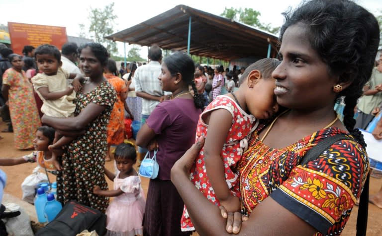 A Tamil woman holds a baby girl at a camp for internally displaced people in the northern town of Vavuniya