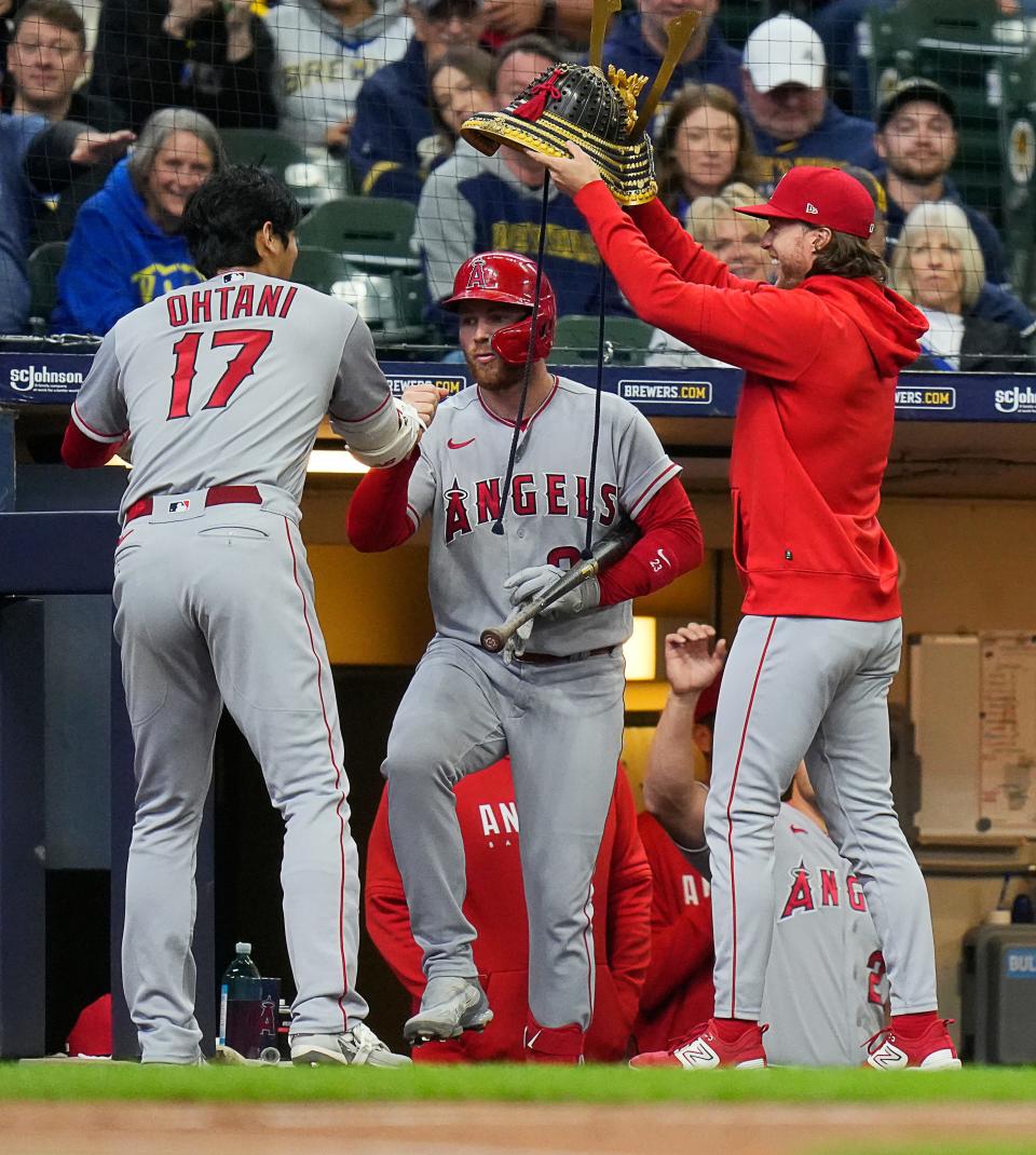 Angels designated hitter Shohei Ohtani (17) puts on a samurai helmet after scoring a homer to center on the first pitch during the third inning against the Brewers on Sunday April 30, 2023 at American Family Field in Milwaukee, Wis.