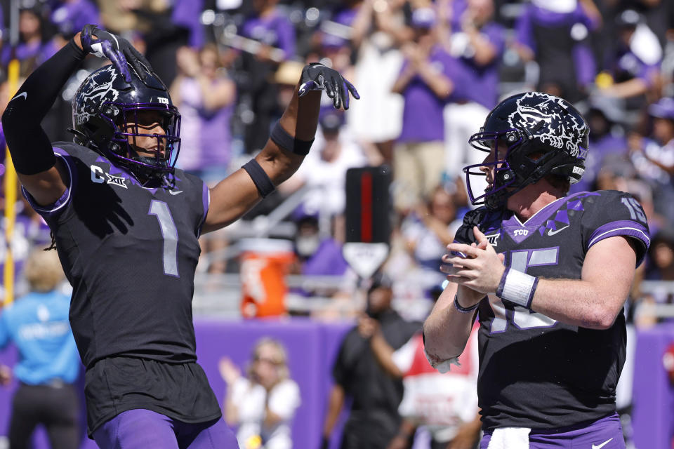 TCU quarterback Max Duggan (15) and teammate Quentin Johnston (1) celebrate Duggan's touchdown against Oklahoma during the second half of an NCAA college football game Saturday, Oct. 1, 2022, in Fort Worth, Texas. TCU won 55-24. (AP Photo/Ron Jenkins)