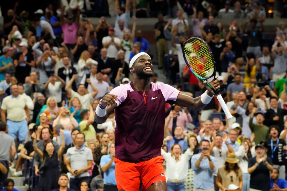 Frances Tiafoe celebrates after winning a fourth set tiebreaker against Carlos Alcaraz.