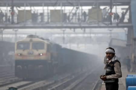 A man stands on railway platform on a smoggy morning in New Delhi, India, November 10, 2017. REUTERS/Saumya Khandelwal