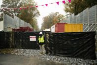 In this Tuesday, Oct. 22, 2019 photo, a worker stands by the gate of a construction site along the Mariner East pipeline in Exton, Pa. The 350-mile (560-kilometer) pipeline route traverses those suburbs, close to schools, ballfields and senior care facilities. The spread of drilling, compressor stations and pipelines has changed neighborhoods — and opinions. (AP Photo/Matt Rourke)