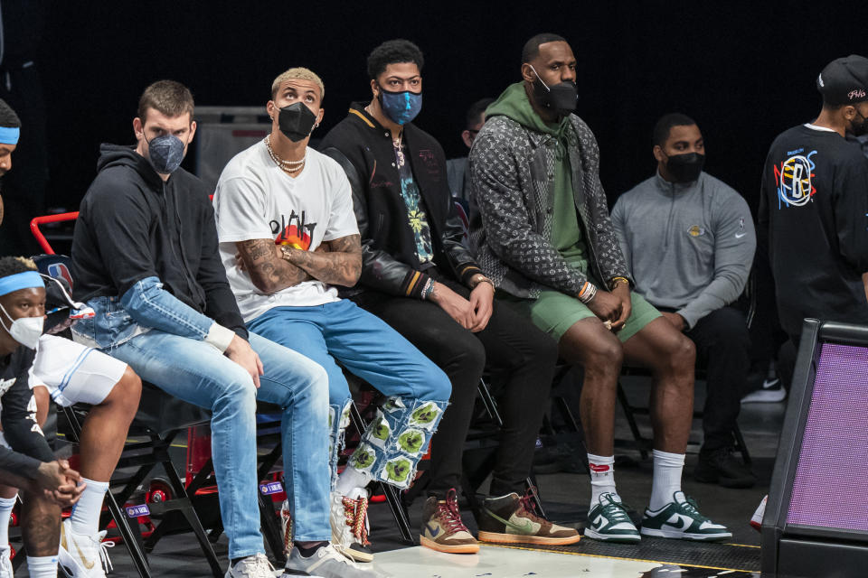 Los Angeles Lakers center Marc Gasol, forward Kyle Kuzma, forward Anthony Davis and forward LeBron James sit on the bench during the first half of the team's NBA basketball game against the Brooklyn Nets, Saturday, April 10, 2021, in New York (AP Photo/Corey Sipkin).