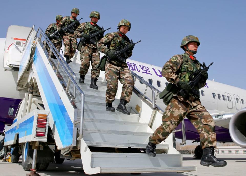 This photo taken on February 27, 2017 shows Chinese military police getting off a plane to attend an anti-terrorist oath-taking rally in Hetian, northwest China's Xinjiang Uighur Autonomous Region.<span class="copyright">AFP via Getty Images</span>