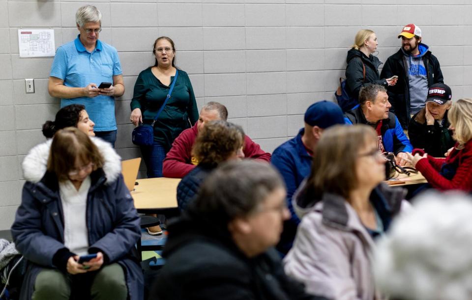 Michael Porter Sr. and his wife Natalia of Huntington Beach observe the process during caucuses night.