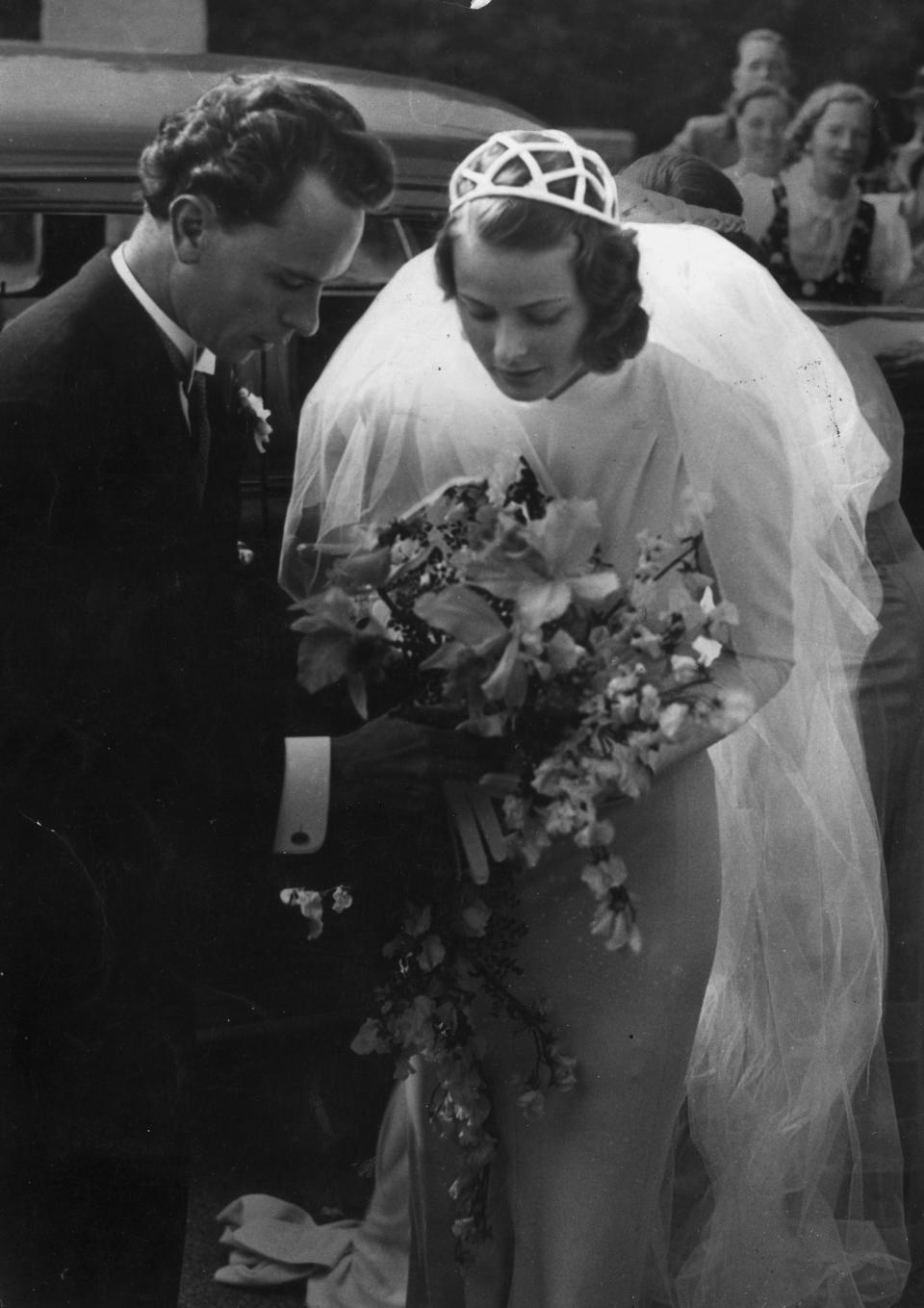 Ingrid Bergman and her husband Dr. Petter Lindstrom hold the bridal bouquet together.