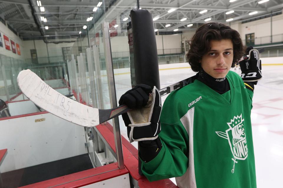 Wayland High sophomore Sam Brande poses for a photos before practice with the Wayland boys hockey team on Jan. 14, 2022. He has started a petition to require neck guards for hockey players because of the death of Teddy Balkind, a good friend, who recently died because of a hockey accident. Balkind's initials and uniform number now adorn Brande's hockey stick.