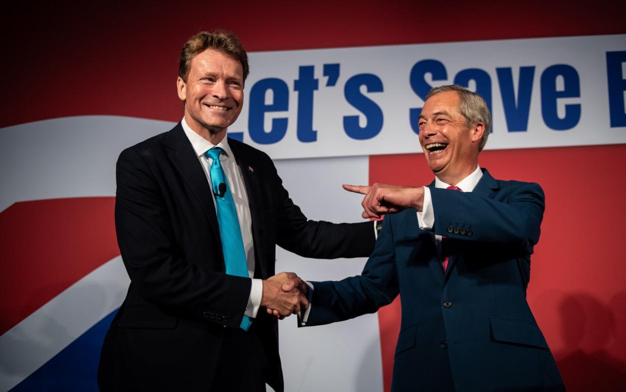 Nigel Farage and Richard Tice shake hands at Reform's annual conference in October 2023