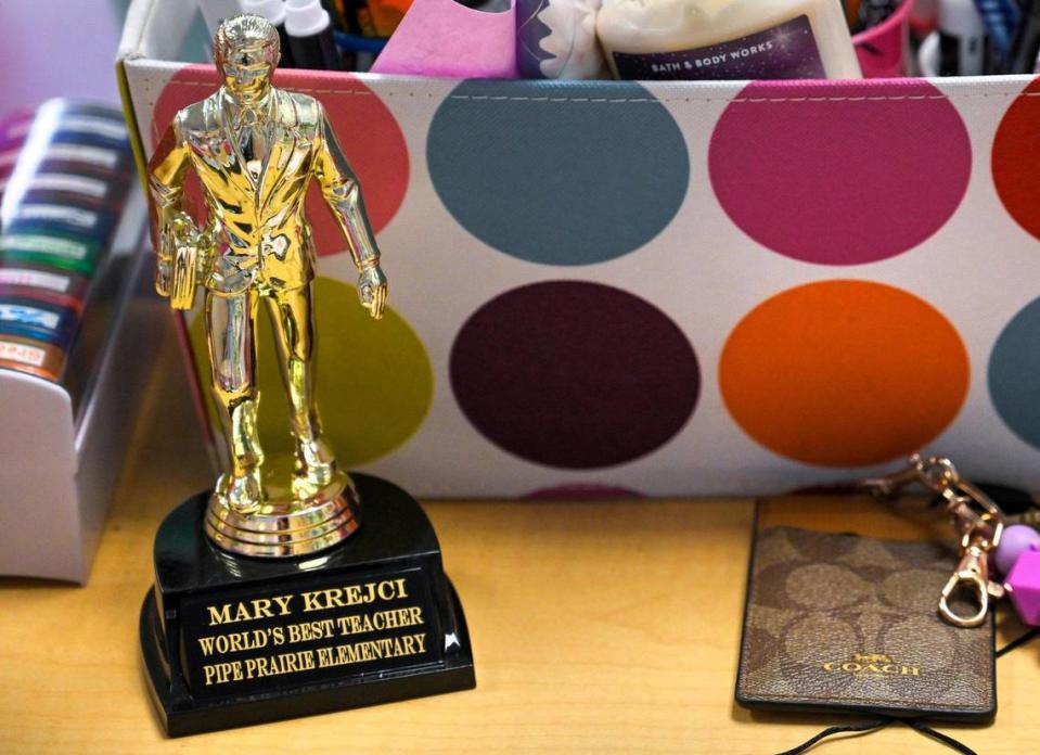 First grade teacher Mary Krejci displays the Dundie Award she received from a parent and her son who nominated Krejci for the Kansas City Star’s Honor Roll teacher poll, which she won. Krejci, a teacher at Piper Prairie Elementary School, displayed the trophy in her classroom on May 10, 2023, in Kansas City, Kansas.