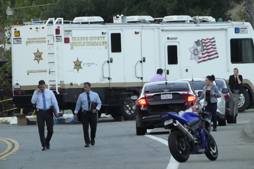 Law enforcement personnel stage at the scene of a mass shooting outside Cook's Corner, Thursday, Aug. 24, 2023, in Trabuco Canyon, Calif. (AP Photo/Damian Dovarganes)