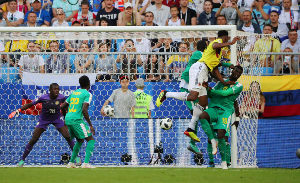 <p>Yerry Mina scores the only goal of the match against Senegal </p>