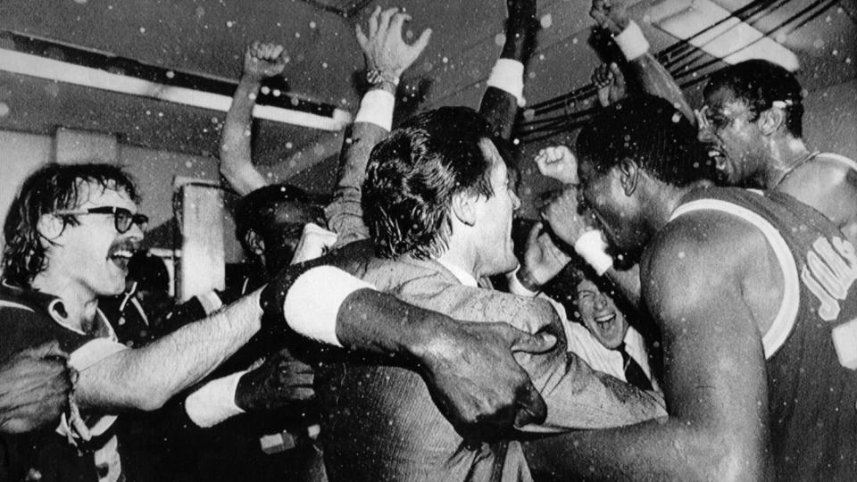 The Lakers' Kurt Rambis, coach Pat Riley and Magic Johnson celebrate with the rest of the team.