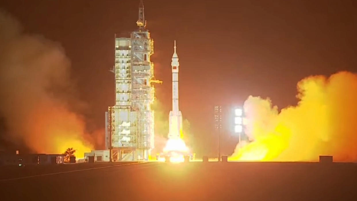  A rocket launches in the early morning hours above a plume of fire. 