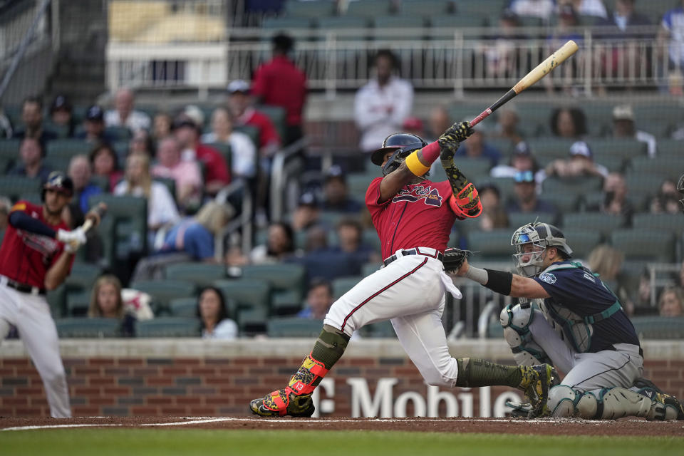 Atlanta Braves' Ronald Acuna Jr., second from right, hits a double in the first inning of a baseball game against the Seattle Mariners, Friday, May 19, 2023, in Atlanta. (AP Photo/Brynn Anderson)