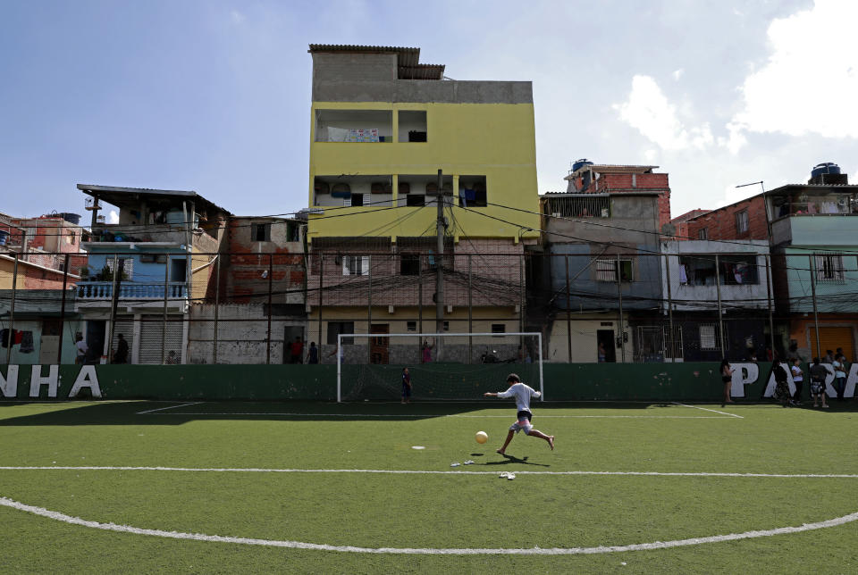 SAO PAULO, BRAZIL - MARCH 24: A kid play soccer during training to distribute donated food to residents of Paraisópolis favela on March 24, 2020 in Sao Paulo, Brazil. Paraisopolis is the second largest favela in the city of Sao Paulo housing more than 100 thousand people and so far has five coronavirus (COVID-19) positive cases reported. According to the Ministry of health, Brazil has 2201 confirmed cases infected with the coronavirus (COVID-19) and at least 46 recorded deceases. (Photo by Rodrigo Paiva/Getty Images)