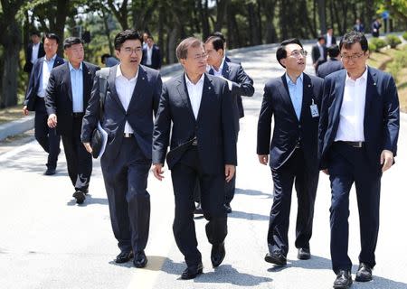 South Korean President Moon Jae-in walks during his visit to the state-run Agency for Defense Development in Taean, South Korea, in this handout picture provided by the Presidential Blue House and released by Yonhap on June 23, 2017. The Presidential Blue House/Yonhap via REUTERS