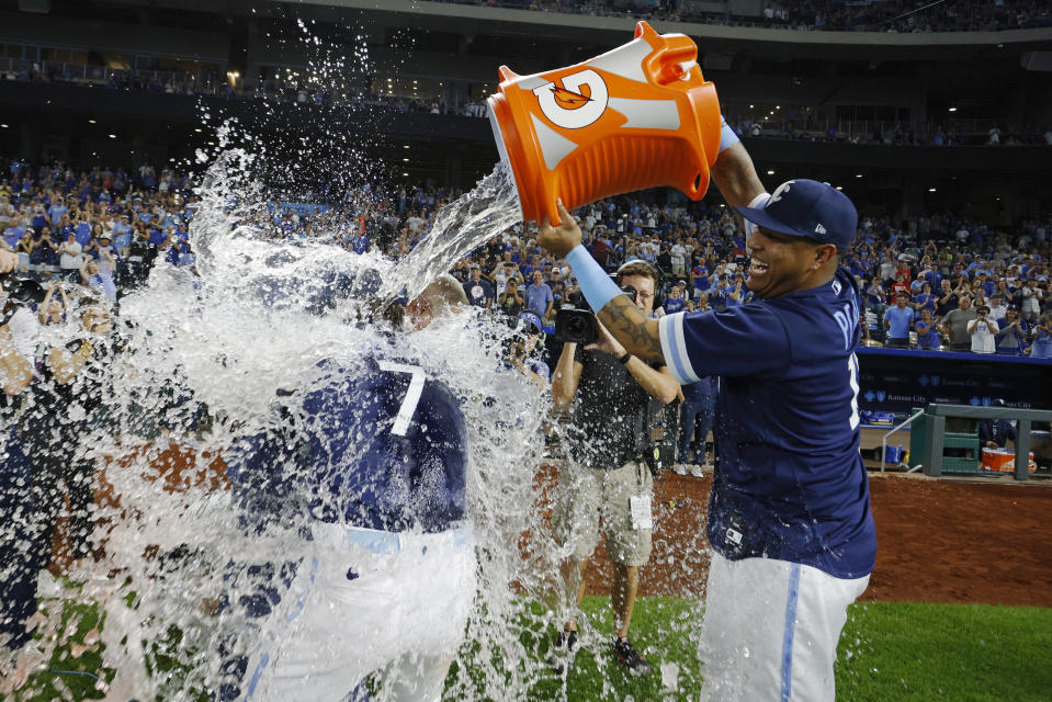 Kansas City Royals' Bobby Witt Jr. (7) gets doused by Salvador Perez, right, after the team's baseball game against the New York Yankees in Kansas City, Mo., Friday, Sept. 29, 2023. (AP Photo/Colin E. Braley)