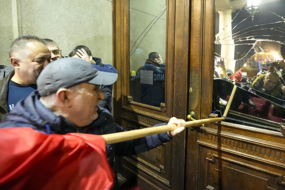 Opposition supporters attempt to enter the capital's city council building in protest of what election observers said were widespread vote irregularities during a general election last weekend in Belgrade, Serbia, Sunday, Dec. 24, 2023. The country's populist authorities have denied rigging the vote. President Aleksandar Vucic said Sunday that those claims were blatant "lies" promoted by the political opposition. (AP Photo/Darko Vojinovic)