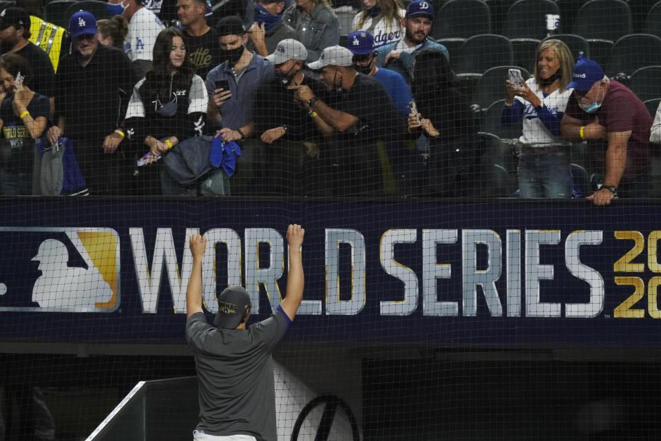 Los Angeles Dodgers shortstop Corey Seager poses for a fan after defeating the Tampa Bay Rays 3-1 to win the baseball World Series in Game 6 Tuesday, Oct. 27, 2020, in Arlington, Texas. (AP Photo/Tony Gutierrez)