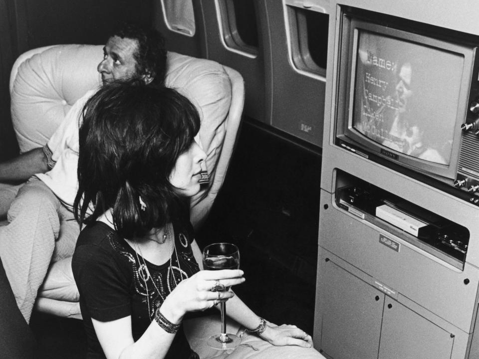 A young woman sits in front of the TV on the Starship during Led Zeppelin's 1973 tour.