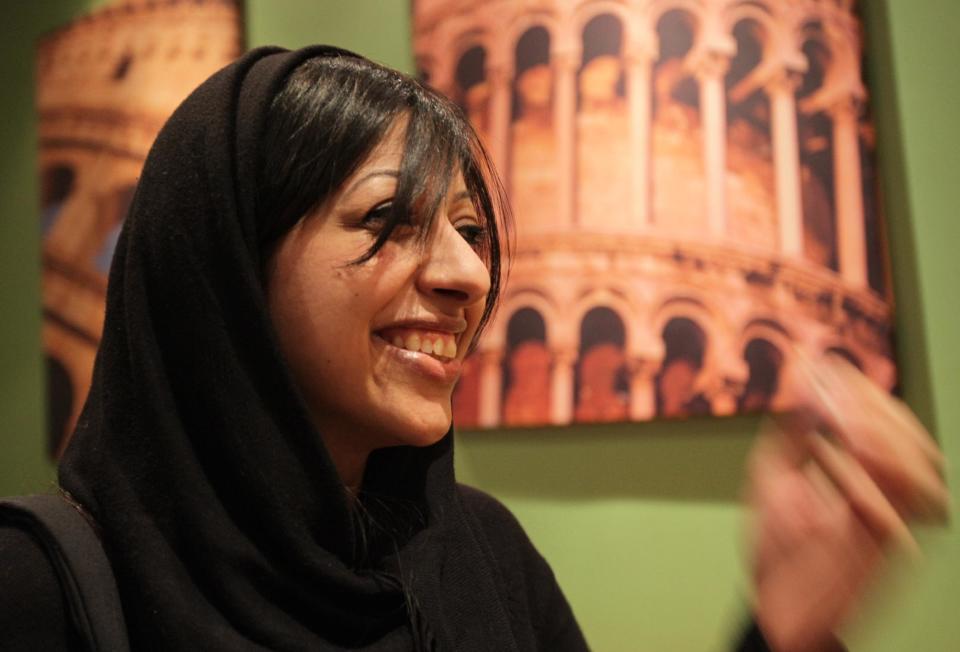 Bahraini activist Zainab al-Khawaja smiles hours after being released from jail at a coffee shop in Abu Saiba, Bahrain, west of the capital of Manama, on Sunday, Feb. 16, 2014. A lawyer for al-Khawaja, she has been released from prison after nearly a year behind bars for multiple convictions including participation in an illegal gathering. (AP Photo/Hasan Jamali)