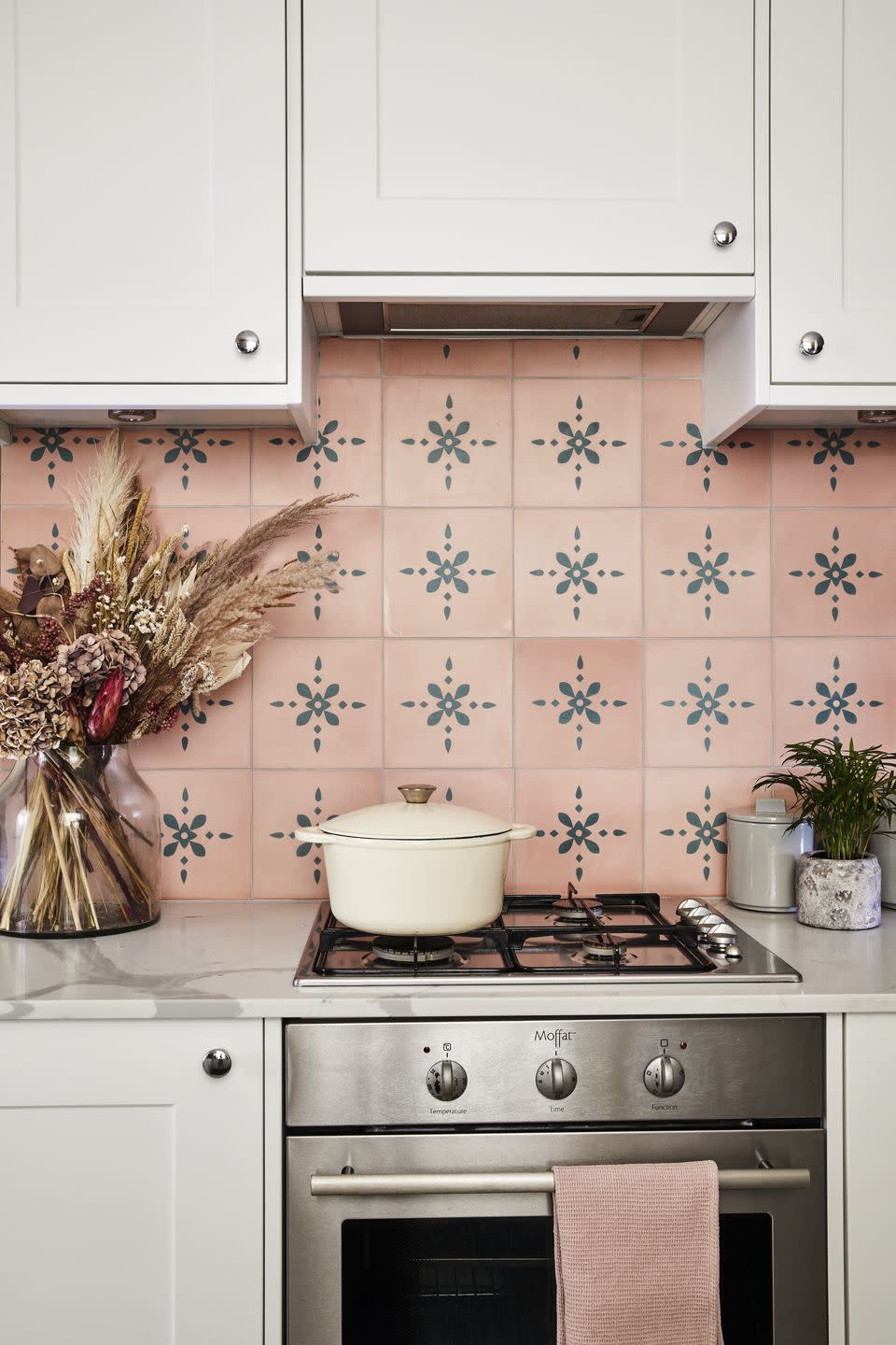 pink tile splash back with hob