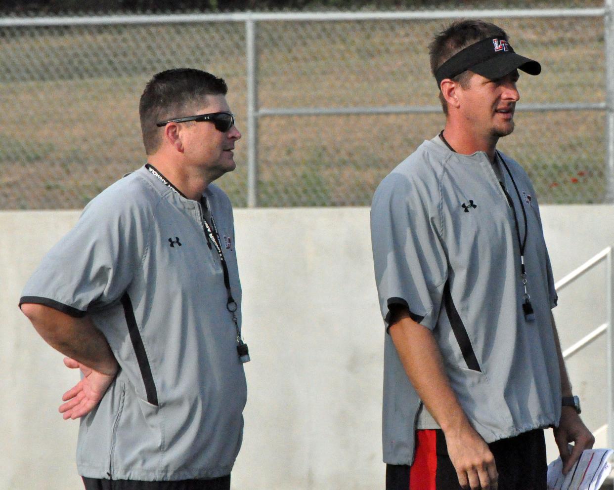 Michael Wall, right, and Lake Travis head football coach Hank Carter watch a practice during Wall's tenure as offensive coordinator at Lake Travis. Wall, who spent the previous four seasons as head coach at Willis, has been hired as the new football coach at East View High School in the Georgetown school district.