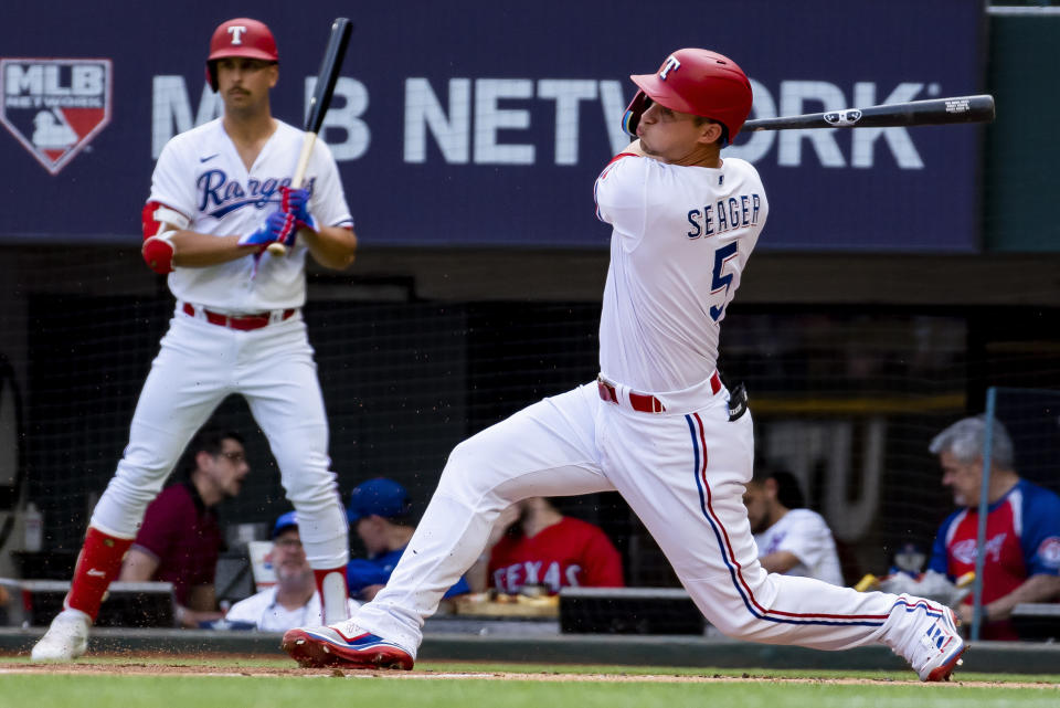 Texas Rangers' Corey Seager (5) swings at a pitch in the first inning in a baseball game against the Philadelphia Phillies in Arlington, Texas, Saturday, April 1, 2023. (AP Photo/Emil T. Lippe)